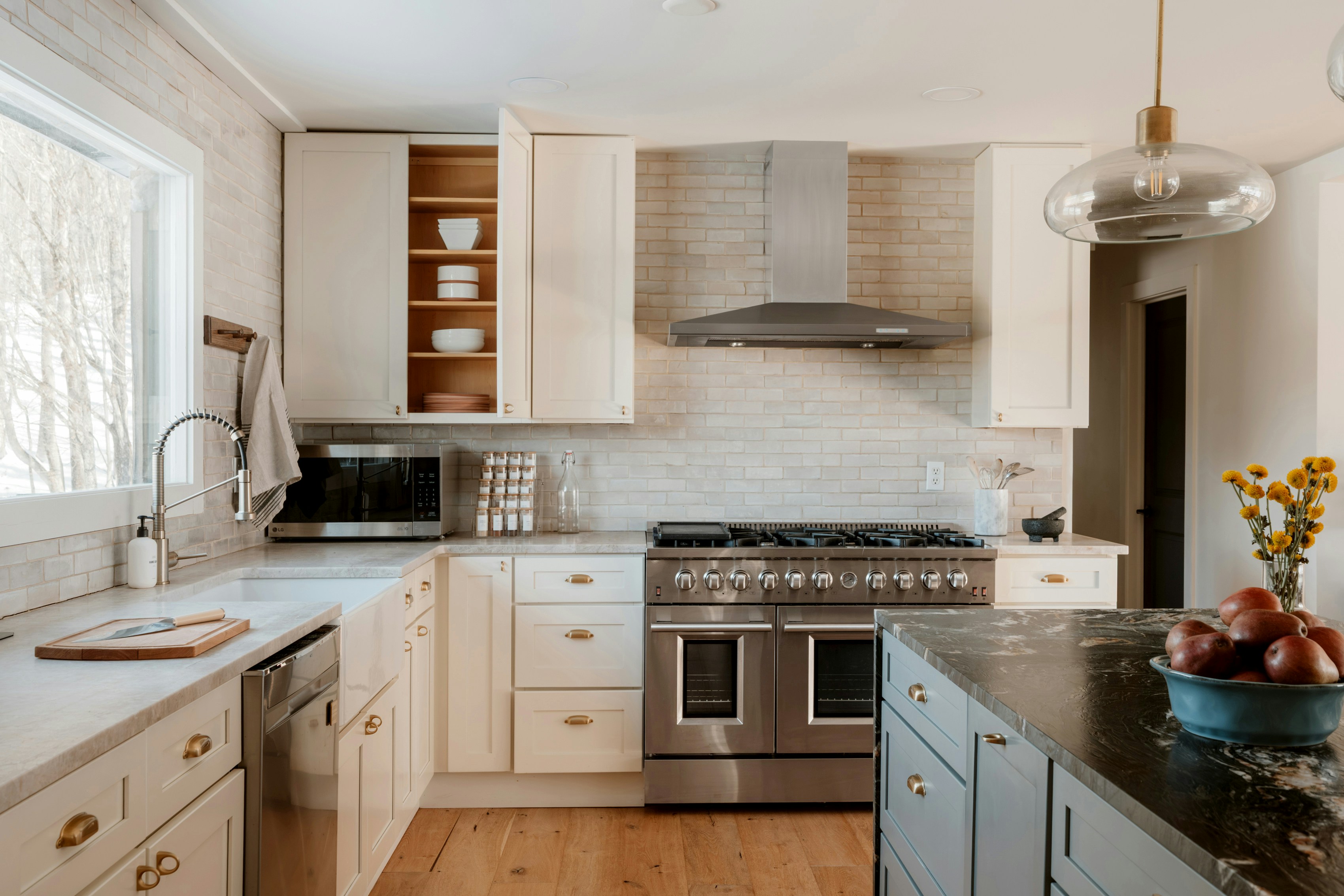 Clean modern kitchen with white cabinets and stainless-steel appliances